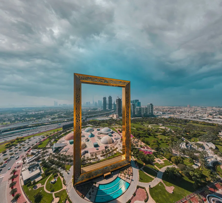 The golden Dubai Frame with the city skyline behind it