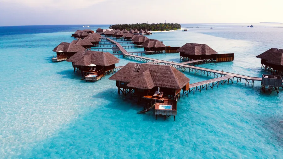 Overwater villas above turquoise water in the Maldives
