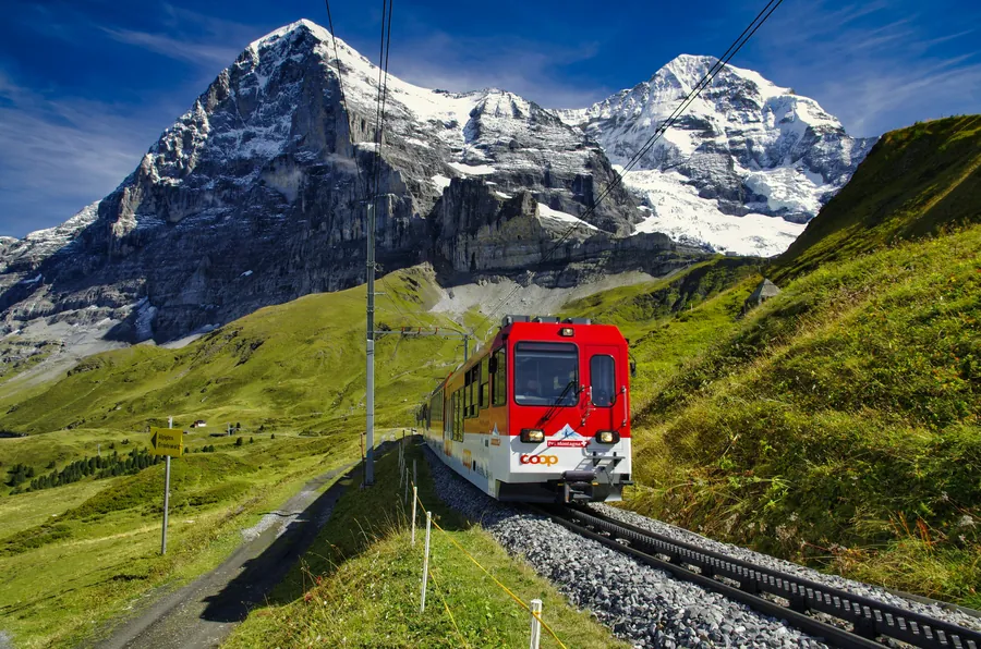 Red mountain train in front of the snowy Eiger in Switzerland